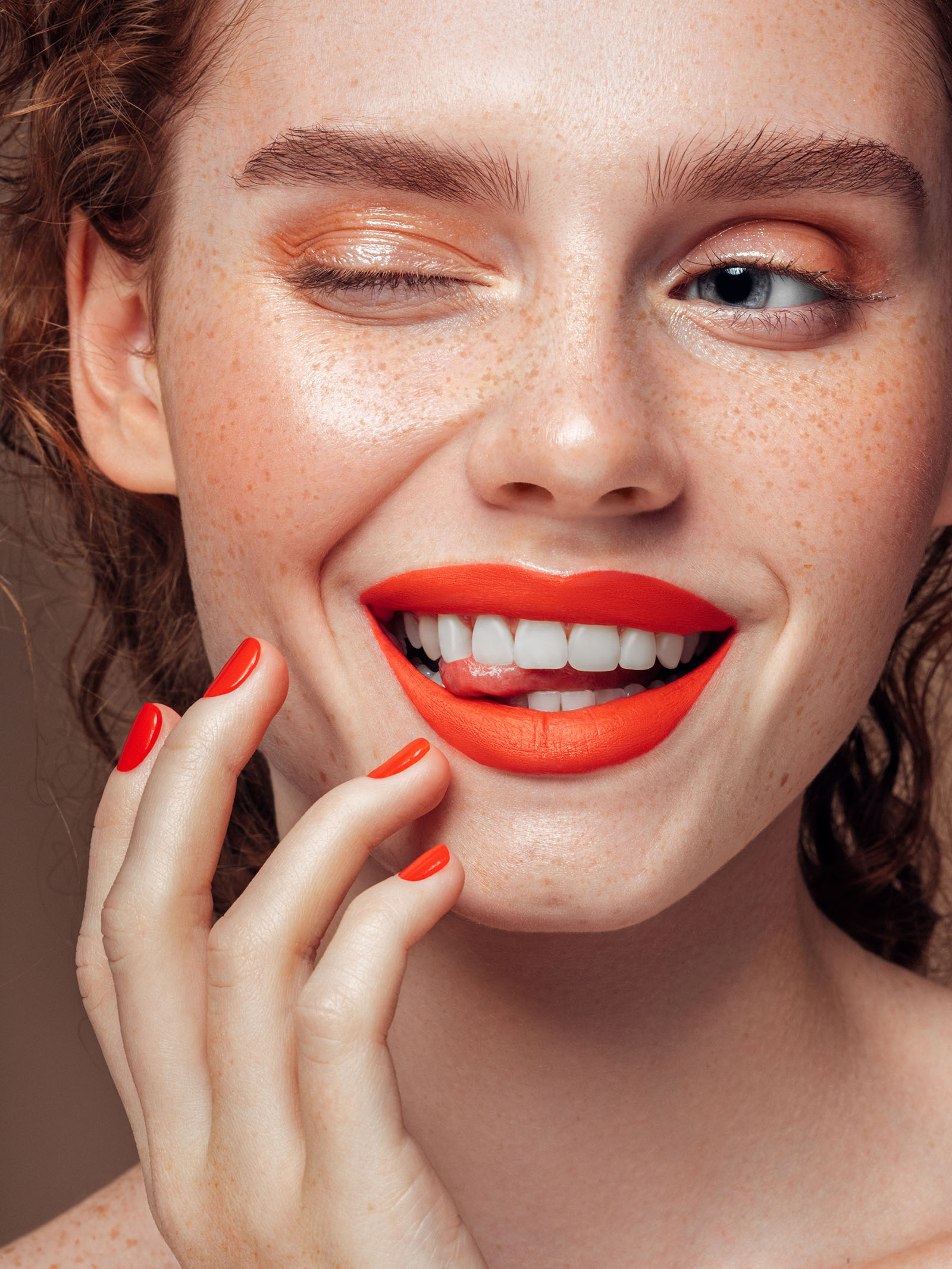 model showing how to wear orange lipstick
